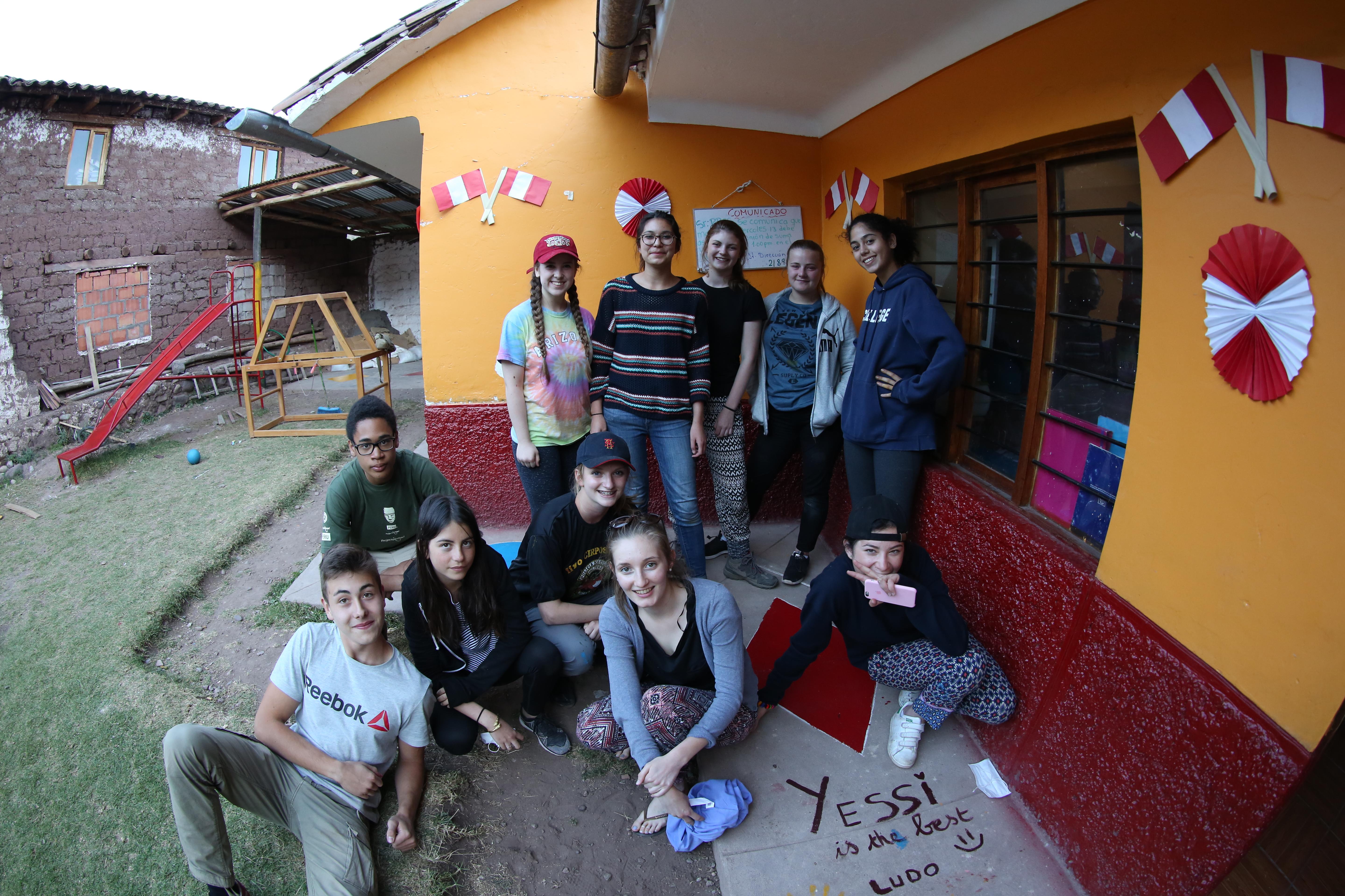 A group of teenage community volunteers working in Peru, rest at their placement during a break. Teenage volunteers doing work with children in Peru, take a break during the day.